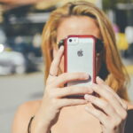 Woman taking selfie with smartphone.