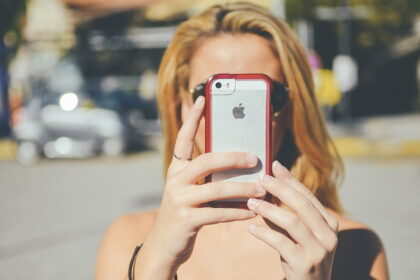 Woman taking selfie with smartphone.