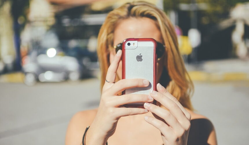 Woman taking selfie with smartphone.