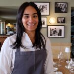 Waitress in a restaurant setting.