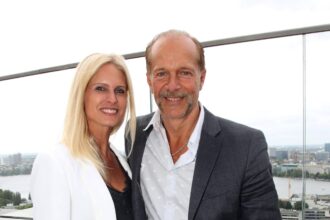 Couple posing on a rooftop terrace.