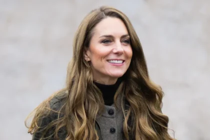 Long hair, casual outfit, serene expression.