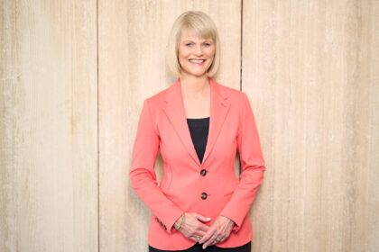 Smiling woman in coral blazer
